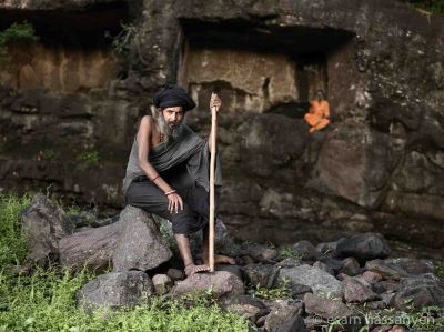 Jogi Balaknath Baba sits for a portrait in front of the cave he lives cut into the rock in Nashik, India.